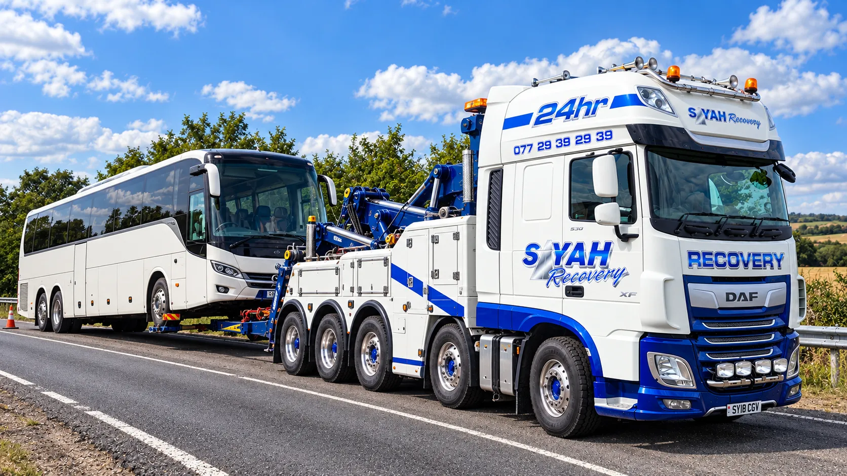 Heavy recovery wrecker towing a coach