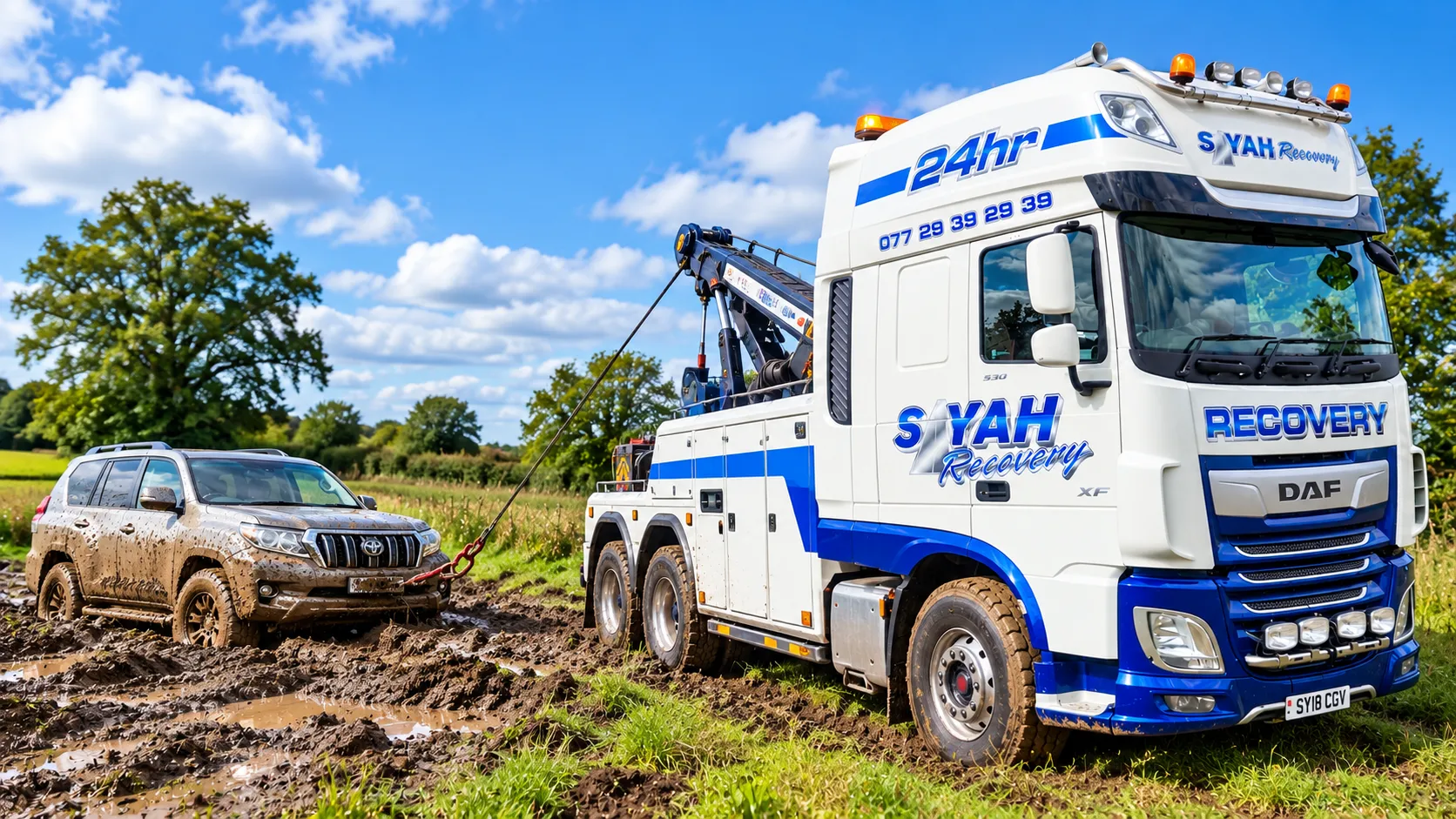Car being winched out of a muddy field